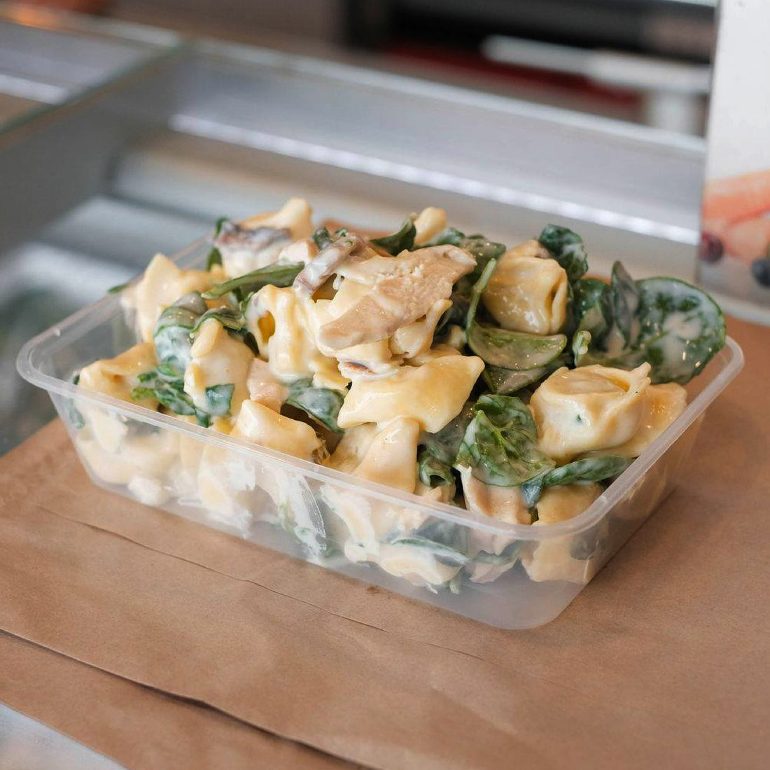 creamy chicken and spinach leftovers placed in a plastic food container